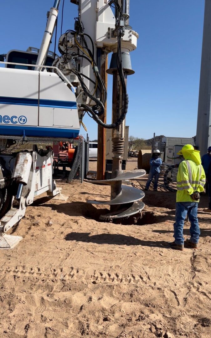 A construction worker standing next to a truck.