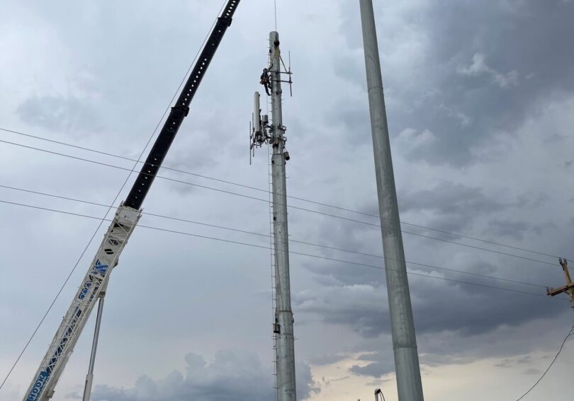 A group of people standing next to some poles.